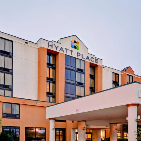 A multi-story Hyatt Place hotel building is shown with a prominent logo and covered entrance.