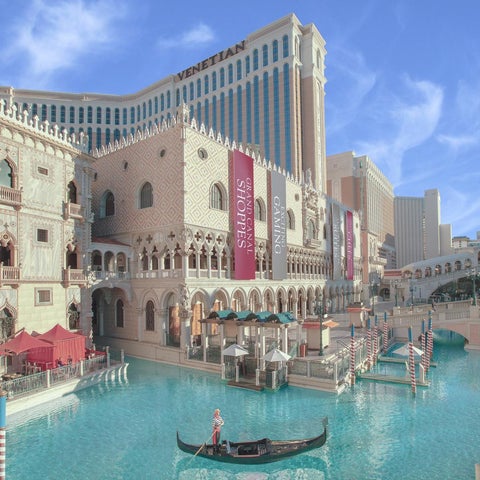 The Venetian Resort in Las Vegas features a canal with gondolas, ornate architecture, and a replica of St. Mark's Campanile.