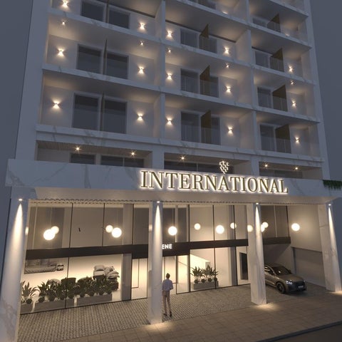 A multi-story hotel building with a modern facade, featuring a prominent 'International' sign and a well-lit entrance area.