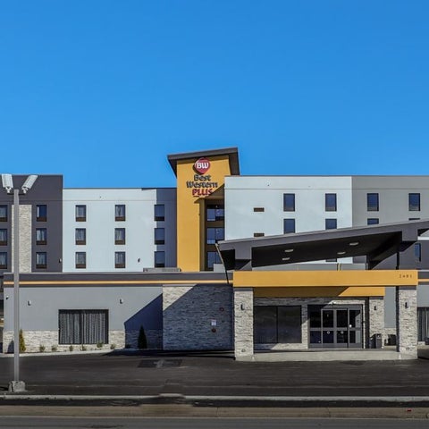 A multi-story Residence Inn by Marriott hotel building is shown with a modern facade and parking lot in front.