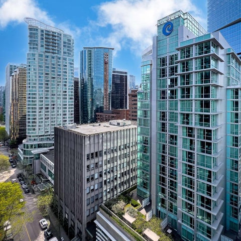 A high-angle view showcases a cluster of modern high-rise buildings with glass facades and a vibrant cityscape backdrop.