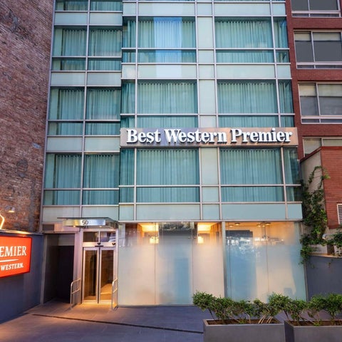The Best Western Premier hotel facade features a modern design with large windows and a prominent entrance.