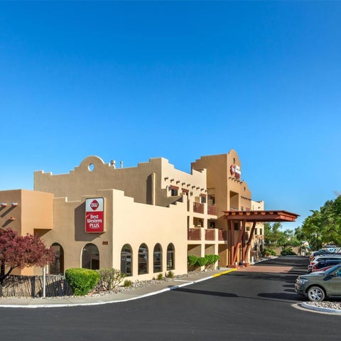 A Best Western Plus hotel building with a distinctive southwestern architectural style and a parking lot in front.