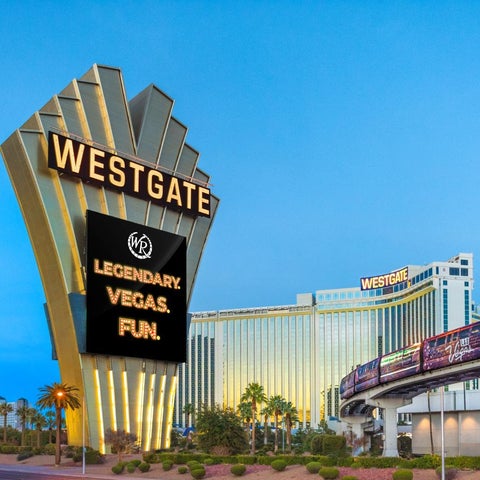 The Westgate Las Vegas sign and building are visible against a blue sky, with a monorail and other buildings in the background.