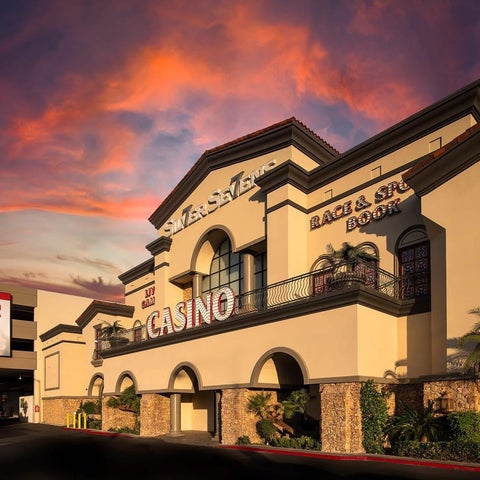 The South Point Hotel, Casino & Spa building is shown with a vibrant sunset sky and a 'Happy Hour' promotion displayed.